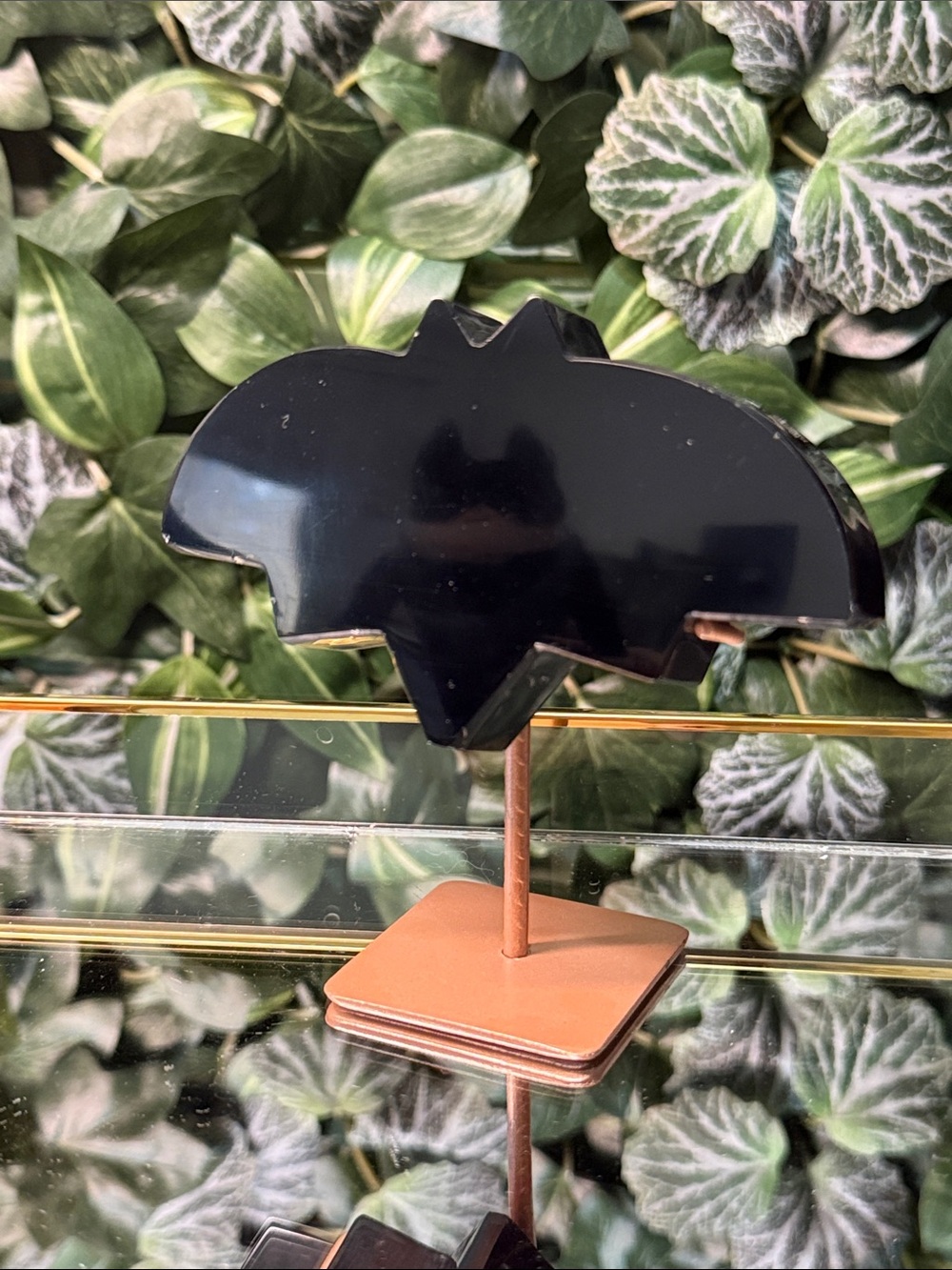 Black obsidian bat on stand